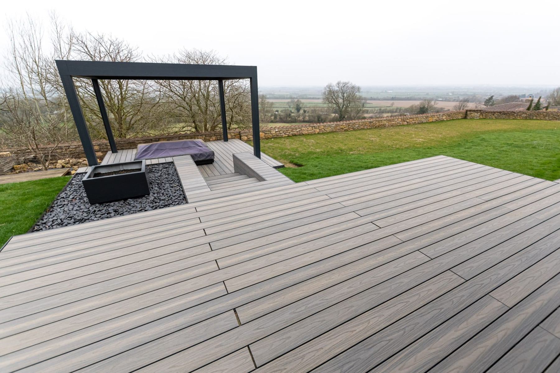 Garden composite deck with pergola and hot tub