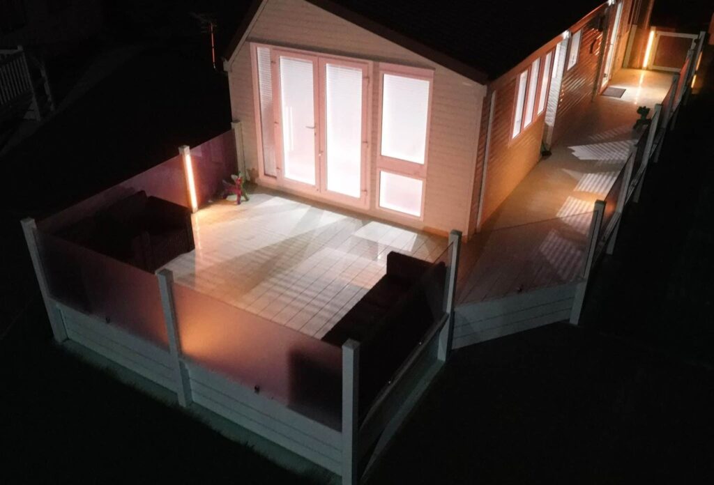 Holiday home deck at night with warm LED lighting